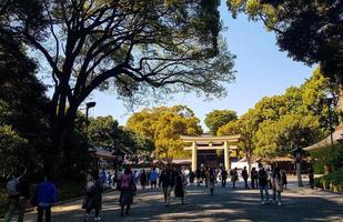 Japan on April 2019. Tourists walking at the entrance of the Harajuku City Forest heading to Meiji Shrine. photo