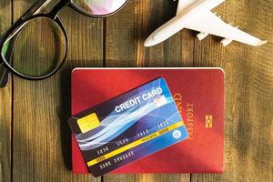 Credit card put on passport on wooden desk photo