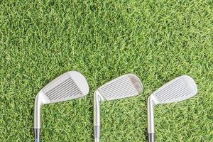 Row of golf club on grass photo