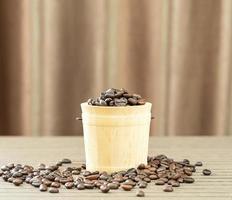 Coffee beans in wood bucket photo