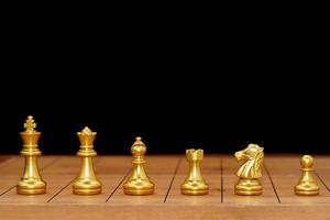 Gold king chess piece stand on wood chessboard photo