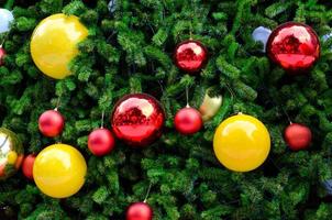 Red and yellow baubles decorate on Christmas tree. photo