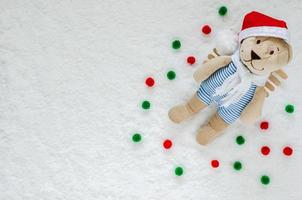 Smilling Santa Claus Teddy bear with snow on the ground for Christmas background concept. photo