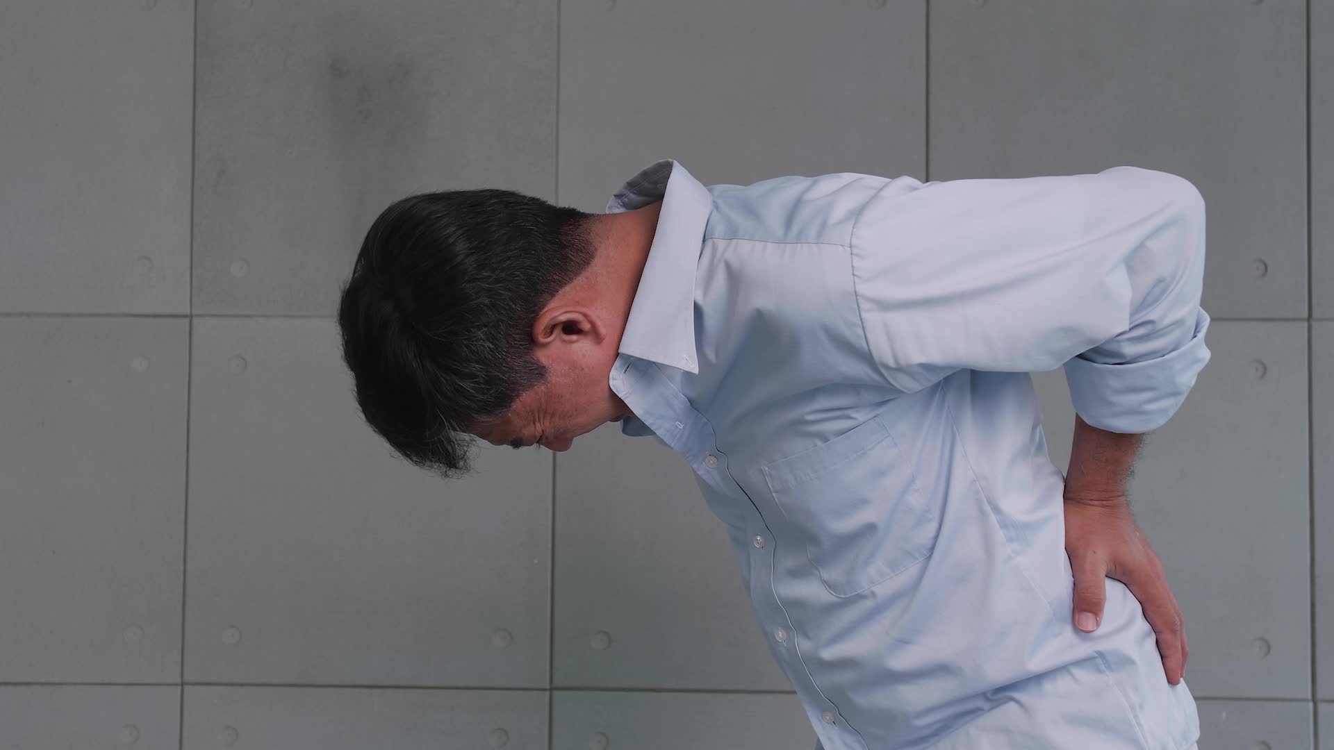 Asian old man back pain after lifting heavy object. 12900595 Stock