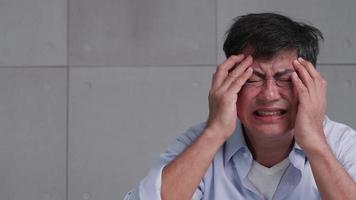anciano asiático con dolor de cabeza por migraña. video