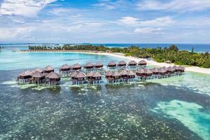 hermoso paraíso de maldivas. paisaje de viaje aéreo tropical, paisaje marino con puente de madera, villas de agua, increíble playa de cielo de arena de mar, naturaleza de isla tropical. turismo exótico destino vacaciones de verano foto