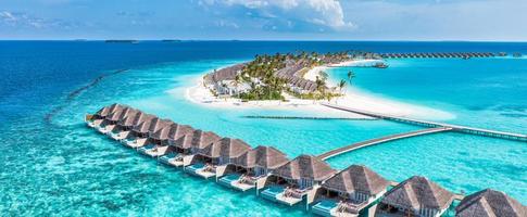 Beautiful Maldives paradise. Tropical aerial travel landscape, seascape with wooden bridge, water villas, amazing sea sand sky beach, tropical island nature. Exotic tourism destination summer vacation photo