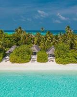 Maldives aerial island landscape. Tropical beach coast from drone. Exotic nature, palm trees over white sand close to coral reef, blue sea, lagoon. Summer and travel vacation concept. Beautiful nature photo