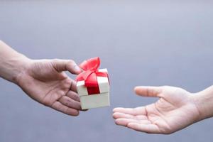 Gift box in hand for lovers on Valentine's Day, New Year, Christmas Day photo