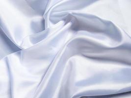 white crumpled fabric texture background. Silk curtain with fold waves for design photo