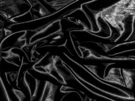 Black satin texture background with liquid wave or wavy folds. Wallpaper design photo