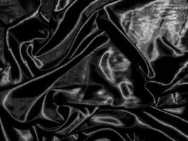 Black satin texture background with liquid wave or wavy folds. Wallpaper design photo