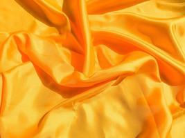 Yellow silk or satin texture background with copy space for design photo