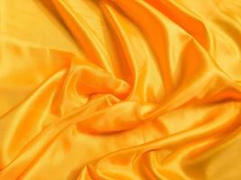 Yellow silk or satin texture background with copy space for design photo