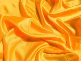 Yellow silk or satin texture background with copy space for design photo