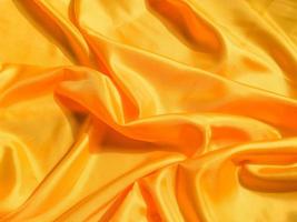 Yellow silk or satin texture background with copy space for design photo