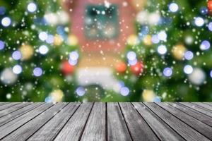 Empty wooden table top with blurred Christmas tree background