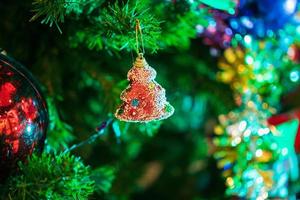 Decorated Christmas baubles on fir tree New Year holidays background photo