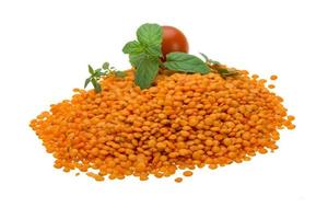 Red lentils on white background photo