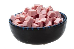 Chopped Sausages in a bowl on white background photo