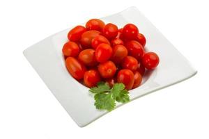 Cherry tomatoes in a bowl on white background photo