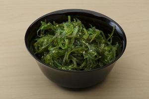 Chuka salad in a bowl on wooden background photo