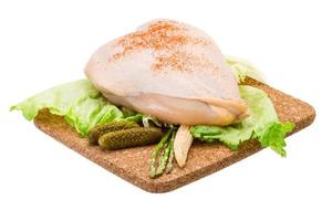 Chicken breast on wooden board and white background photo