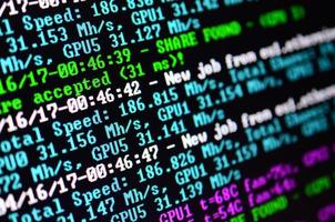 Macro snapshot of the program interface for crypto currency mining on the monitor of an office computer. The concept of mining bitcoins. The flow of information strings and data photo