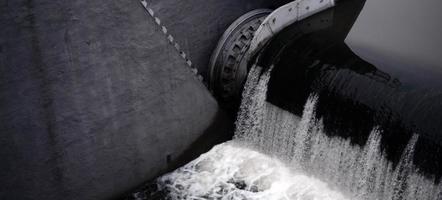 A picture of the flowing water. The dam is designed to regulate the water level in rivers within the city and to provide technical water to industrial objects photo