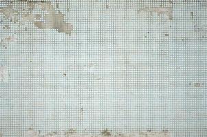 The texture of the old wall, decorated with a lot of square small tiles. Wall in the style of architecture of the Soviet Union photo