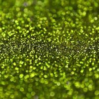 Lime green decorative sequins. Background image with shiny bokeh lights from small elements photo