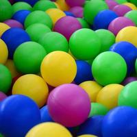 Swimming pool for fun and jumping in colored plastic balls photo