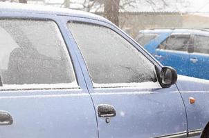 Fragments of parked cars covered with snow photo