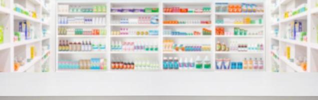 Empty wood counter top with pharmacy drugstore shelves blur pharmaceutical medicine product background photo