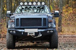 Off-road car on the background of autumn trees photo