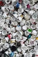 A pattern of many used and soiled nozzles from spray cans with aerosol paint. Background texture of the street art of drawing graffiti on the walls photo