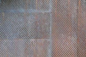 Metal texture with rusty mesh closeup in the daytime outdoors photo