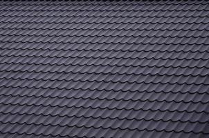 The texture of the roof of painted metal. Close-up detailed view of roof covering for pitched roof. High quality roofing photo