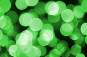 Green abstract Christmas blurred luminous background. Defocused artistic bokeh lights image photo