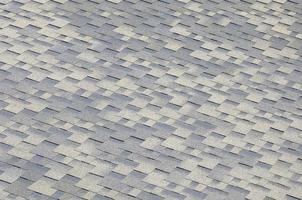 Background mosaic texture of flat roof tiles with bituminous coating photo