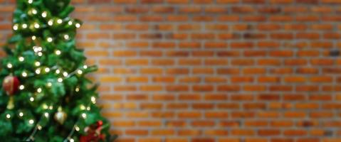 Abstract blur decorated Christmas tree with baubles on brick wall background photo