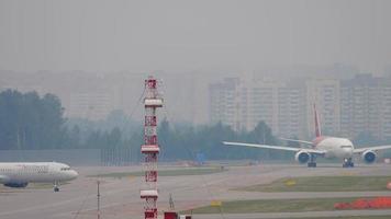 MOSCOW, RUSSIAN FEDERATION JULY 29, 2021 - Airbus A320 Nordwind Air taxiing at Sheremetyevo International Airport. Airplane Nordwind Boeing 777 departure in cloudy rainy weather video