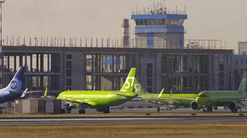 NOVOSIBIRSK, RUSSIAN FEDERATION OCTOBER 20, 2021 - Aircraft of S7 airlines taxiing at the terminal of Tolmachevo airport OVB. S7 Airlines is a Russian airline video