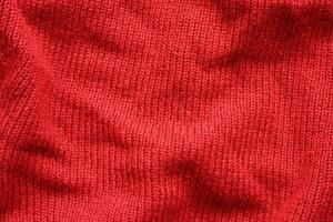 Red knitted wool texture background photo