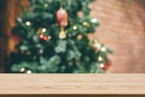 Empty wood table top with abstract blur decorated Christmas tree with baubles New Year holidays background for mockup product display photo