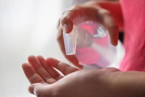 Woman using alcohol sanitizer gel rub for cleaning hand COVID-19 corona virus prevention concept photo