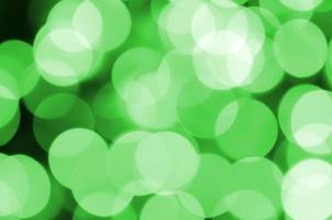 Green abstract Christmas blurred luminous background. Defocused artistic bokeh lights image photo