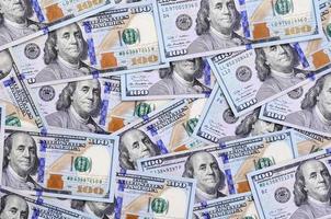 A large number of US dollar bills of a new design with a blue stripe in the middle. Top view photo