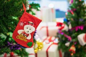 Decorated Christmas socks baubles on fir tree New Year holidays background photo