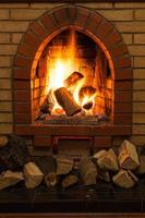 wooden logs and fire in fireplace photo